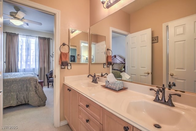 ensuite bathroom with a sink, a ceiling fan, ensuite bath, and double vanity