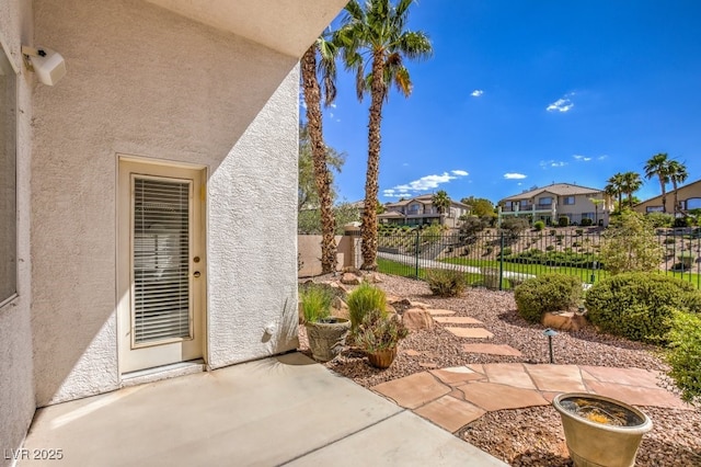 view of patio / terrace with fence and a residential view