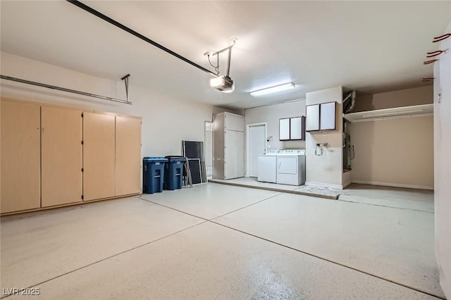 garage with independent washer and dryer and a garage door opener