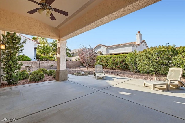 view of patio featuring a ceiling fan and fence