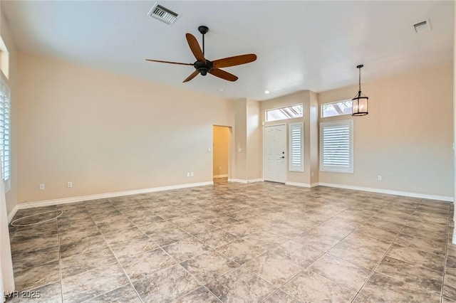 interior space with visible vents, baseboards, and a ceiling fan