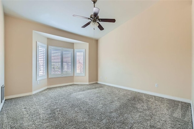 carpeted spare room with baseboards and ceiling fan