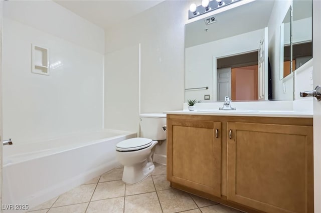 bathroom with vanity, tile patterned floors, toilet, and bathing tub / shower combination