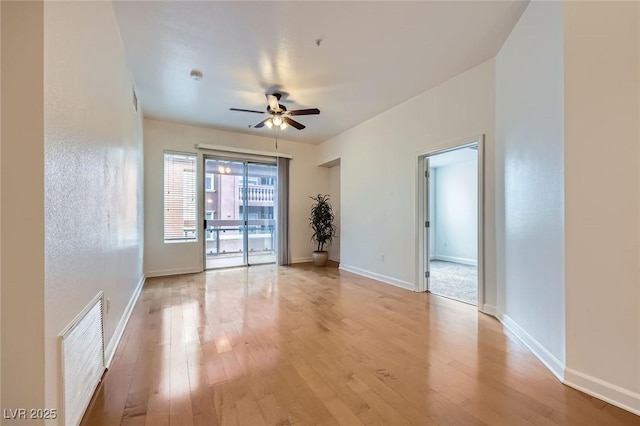 unfurnished room featuring visible vents, baseboards, light wood-style floors, and ceiling fan