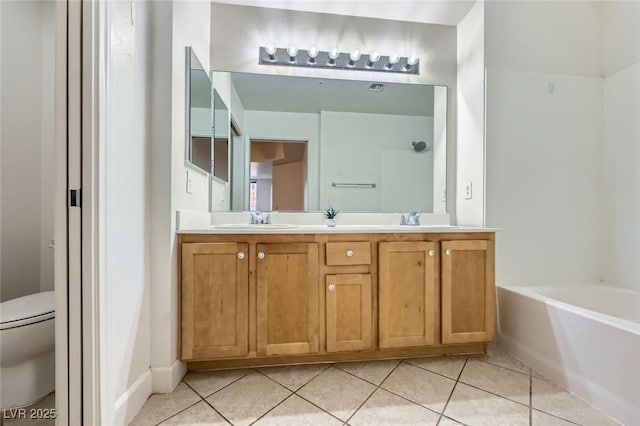 full bathroom featuring tile patterned floors, toilet, a bath, and a sink