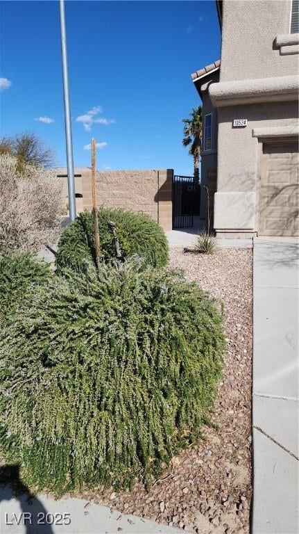 view of yard with an attached garage and fence