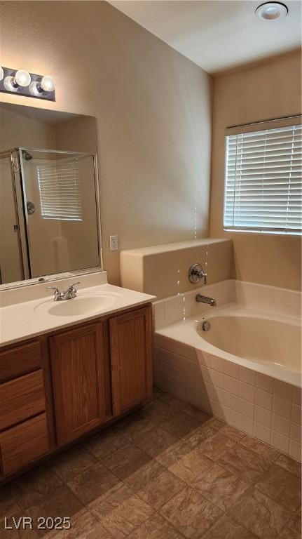 full bath featuring vanity, a garden tub, and a shower stall