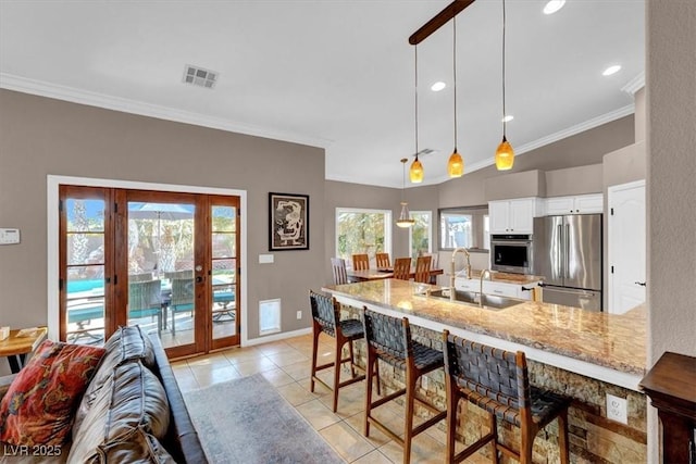 kitchen featuring visible vents, appliances with stainless steel finishes, a peninsula, french doors, and a sink