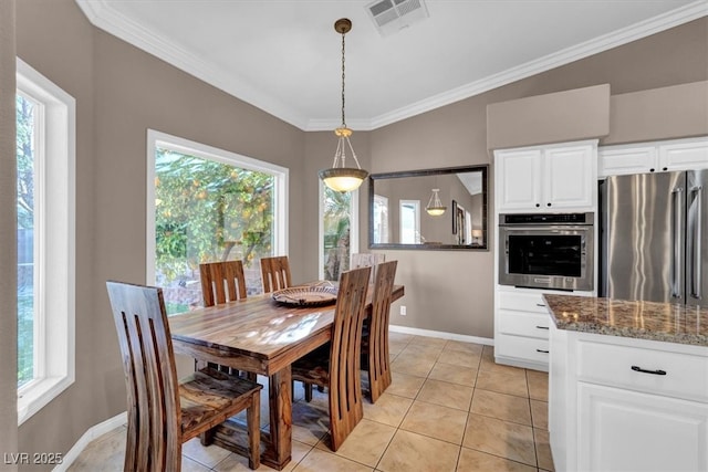 dining space featuring light tile patterned floors, visible vents, baseboards, and crown molding