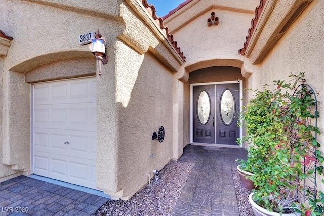 doorway to property with stucco siding and a tile roof