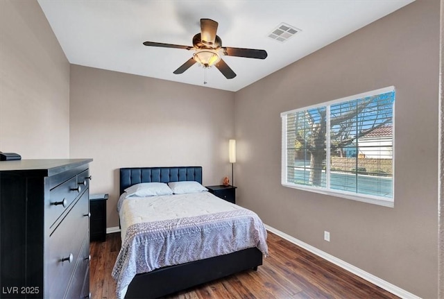 bedroom with visible vents, dark wood-type flooring, and baseboards