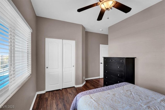 bedroom featuring ceiling fan, baseboards, and wood finished floors