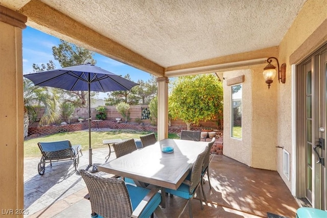 view of patio / terrace with outdoor dining area and fence