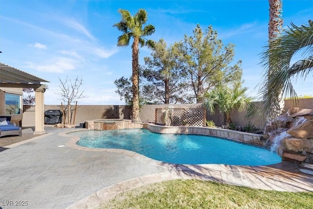 view of pool with a patio, a fenced backyard, a pool with connected hot tub, and grilling area