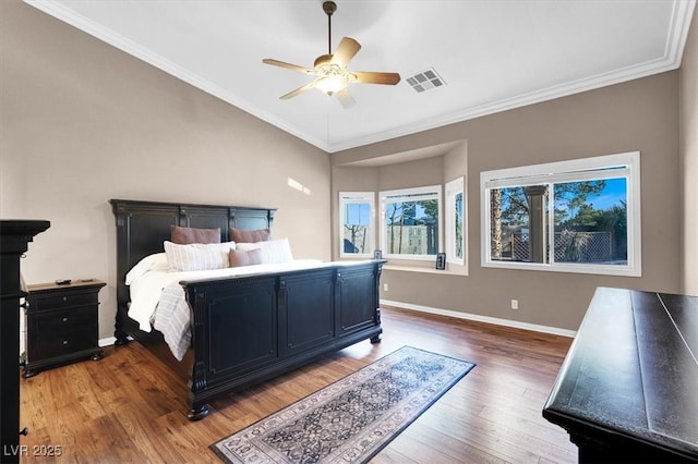 bedroom with wood finished floors, baseboards, visible vents, ceiling fan, and ornamental molding