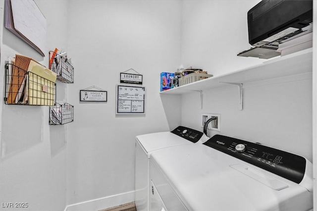 clothes washing area featuring washer and dryer, baseboards, and laundry area