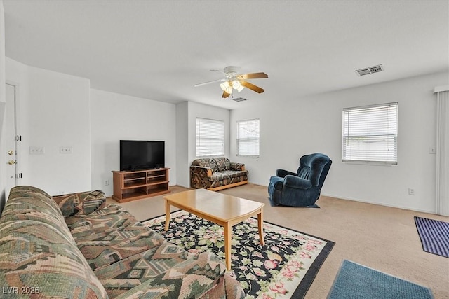 carpeted living room with visible vents and a ceiling fan