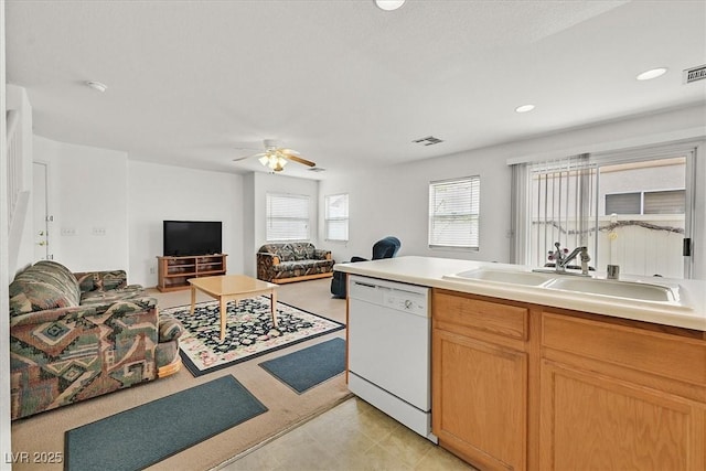 kitchen with visible vents, open floor plan, white dishwasher, a ceiling fan, and a sink