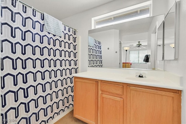 bathroom featuring plenty of natural light, vanity, a shower with shower curtain, and a ceiling fan