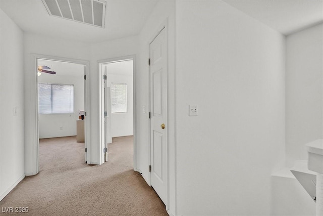 hallway featuring visible vents and carpet floors