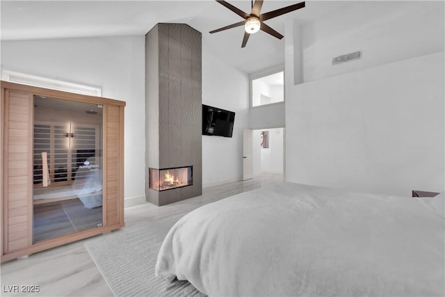 8170 Round Hills Cir, Las Vegas, NV 89113 - bedroom featuring high vaulted ceiling, a multi sided fireplace, and ceiling fan