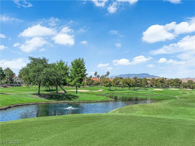 8170 Round Hills Cir, Las Vegas, NV 89113 - view of property's community with a water and mountain view, golf course view, and a lawn