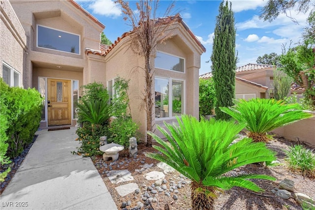 8170 Round Hills Cir, Las Vegas, NV 89113 - doorway to property featuring stucco siding and a tile roof