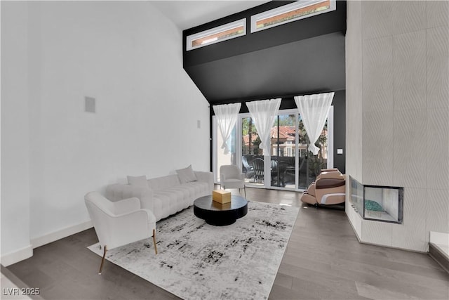 8170 Round Hills Cir, Las Vegas, NV 89113 - living area featuring a high ceiling, wood finished floors, and baseboards