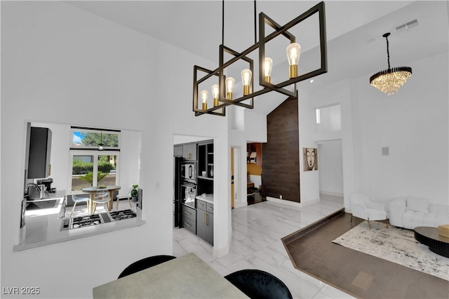 8170 Round Hills Cir, Las Vegas, NV 89113 - dining area with a high ceiling, a chandelier, and marble finish floors