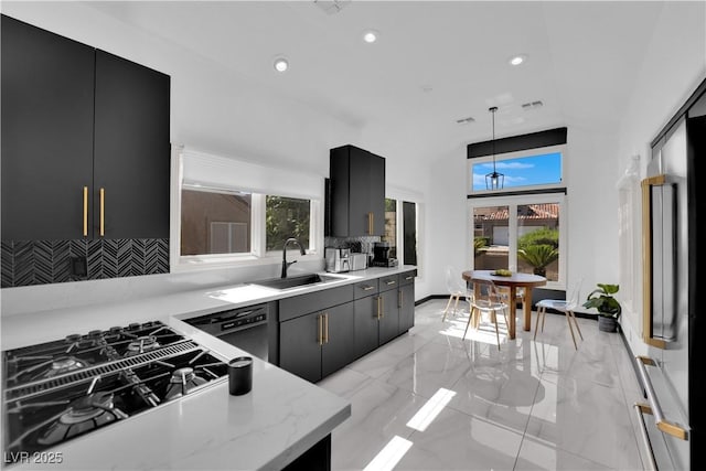 8170 Round Hills Cir, Las Vegas, NV 89113 - kitchen with dishwasher, a sink, stovetop with downdraft, light marble finish flooring, and backsplash