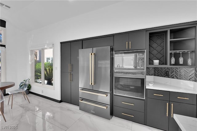 8170 Round Hills Cir, Las Vegas, NV 89113 - kitchen with high end fridge, wall oven, black microwave, light marble finish flooring, and light stone countertops
