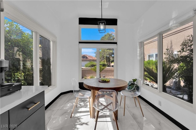 8170 Round Hills Cir, Las Vegas, NV 89113 - sunroom featuring healthy amount of natural light, baseboards, and inlaid floor details