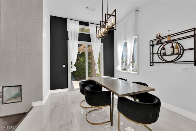 8170 Round Hills Cir, Las Vegas, NV 89113 - dining room with a chandelier, baseboards, and marble finish flooring