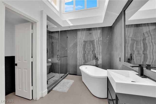 8170 Round Hills Cir, Las Vegas, NV 89113 - bathroom with a shower stall, vanity, a soaking tub, tile patterned floors, and tile walls