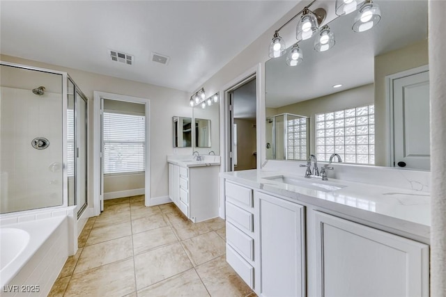 full bath with tile patterned floors, visible vents, a shower stall, and a sink