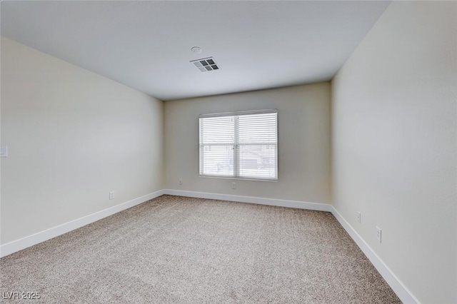 empty room with visible vents, light colored carpet, and baseboards