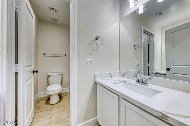 bathroom featuring visible vents, toilet, vanity, and baseboards