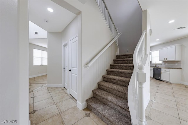 staircase with tile patterned floors, visible vents, recessed lighting, and baseboards