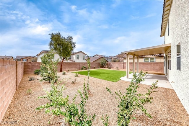 view of yard with a patio and a fenced backyard