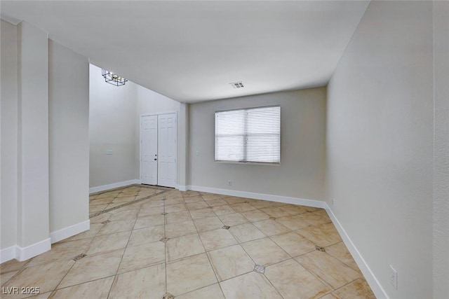 empty room featuring visible vents and baseboards