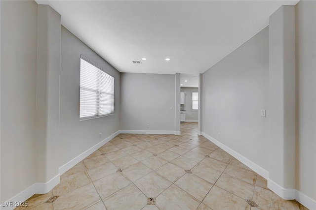 empty room featuring recessed lighting, light tile patterned floors, baseboards, and visible vents