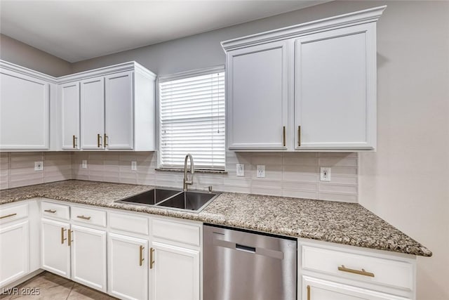 kitchen with stainless steel dishwasher, light stone counters, backsplash, and a sink