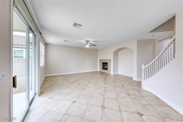 unfurnished living room featuring light tile patterned floors, baseboards, and ceiling fan