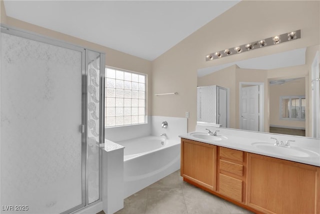 full bath featuring tile patterned flooring, a shower stall, a bath, and a sink