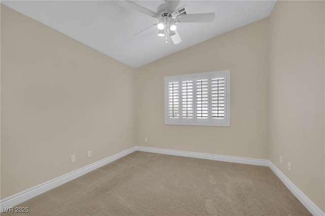 carpeted empty room featuring vaulted ceiling, baseboards, and ceiling fan