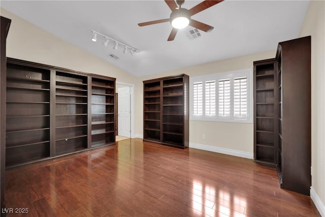 interior space with visible vents, baseboards, vaulted ceiling, wood finished floors, and a ceiling fan