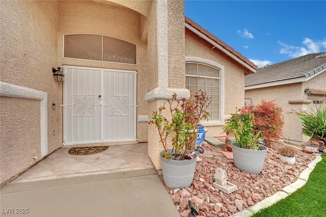 doorway to property with stucco siding