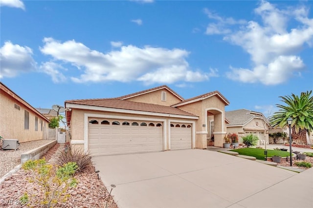 view of front facade featuring concrete driveway, a garage, and stucco siding