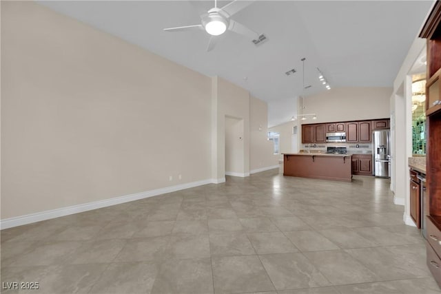 kitchen with visible vents, open floor plan, light countertops, appliances with stainless steel finishes, and a ceiling fan