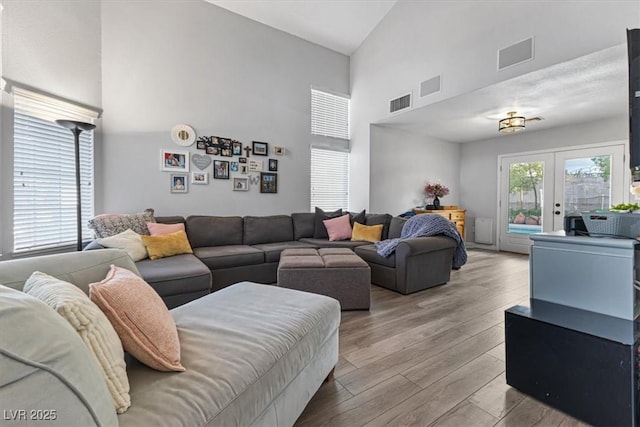 8433 Honeywood Cir, Las Vegas, NV 89128 - living room featuring high vaulted ceiling, wood finished floors, and french doors